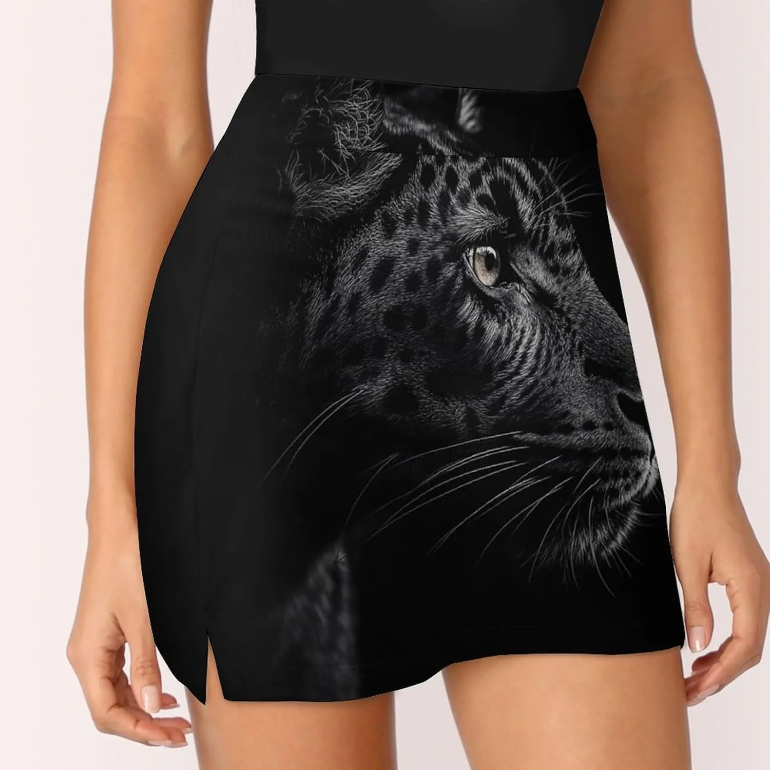 Close-up of Black Leopard Women's Mini Tennis Skirt with Shorts Underneath Athletic Workout Cute Skorts